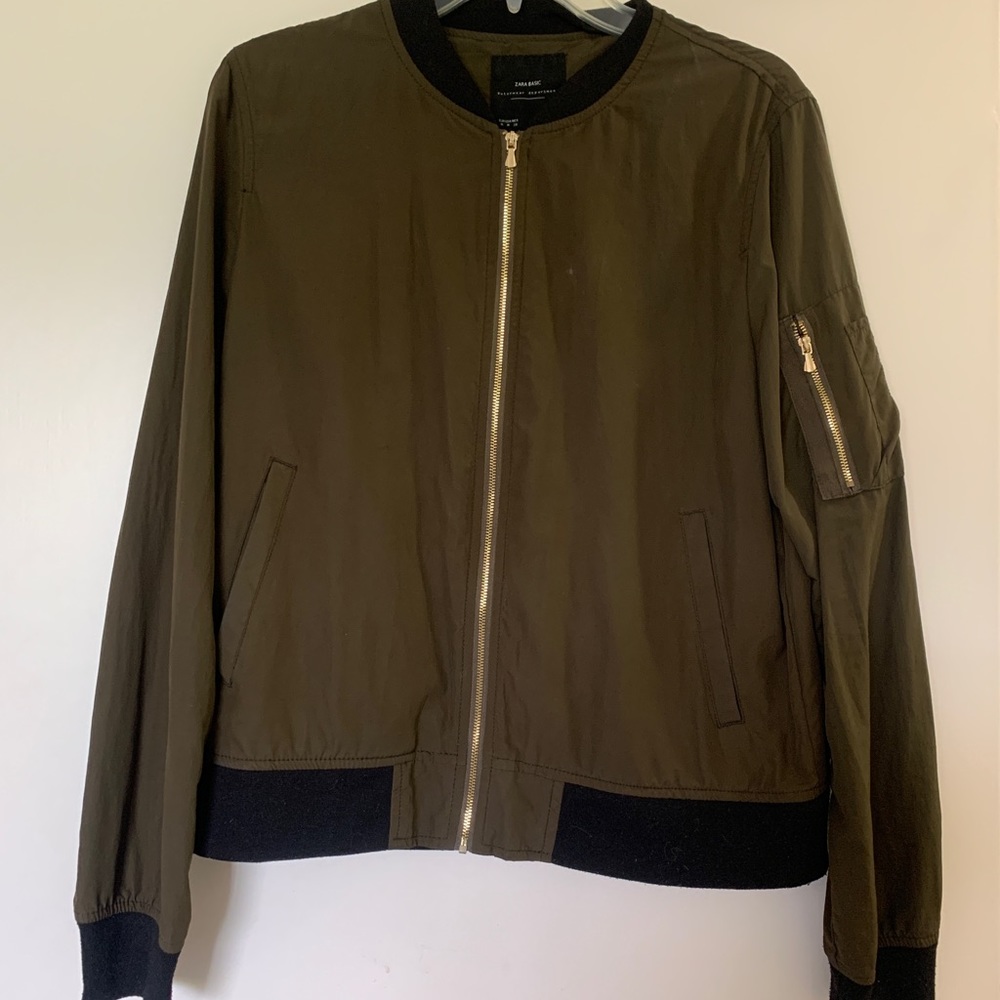 Cool bomber jacket with gold hardware!